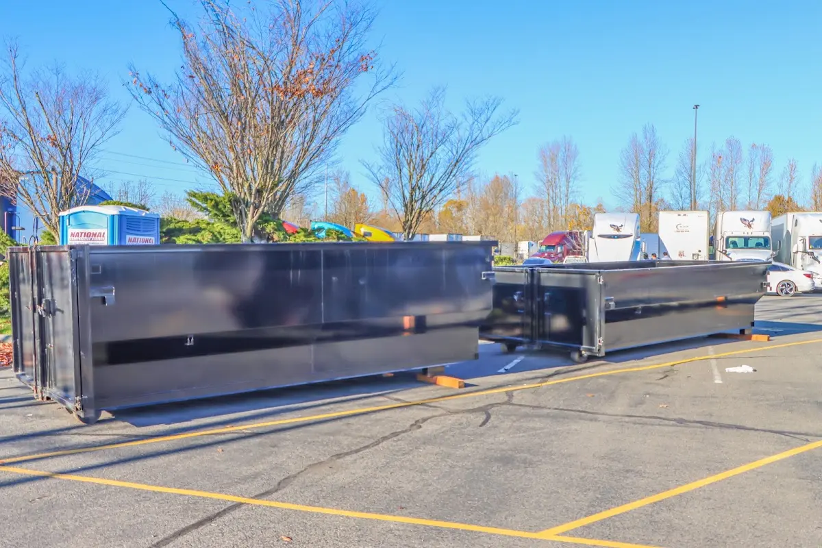 Professional dumpster rental service with roll-off container on residential driveway in White City